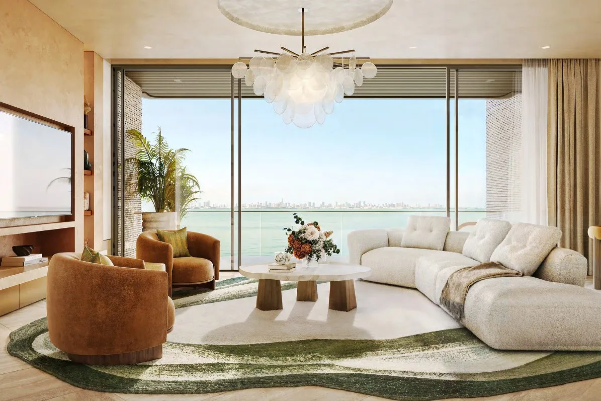Living room with curved sofa and floor-to-ceiling windows onto the sea